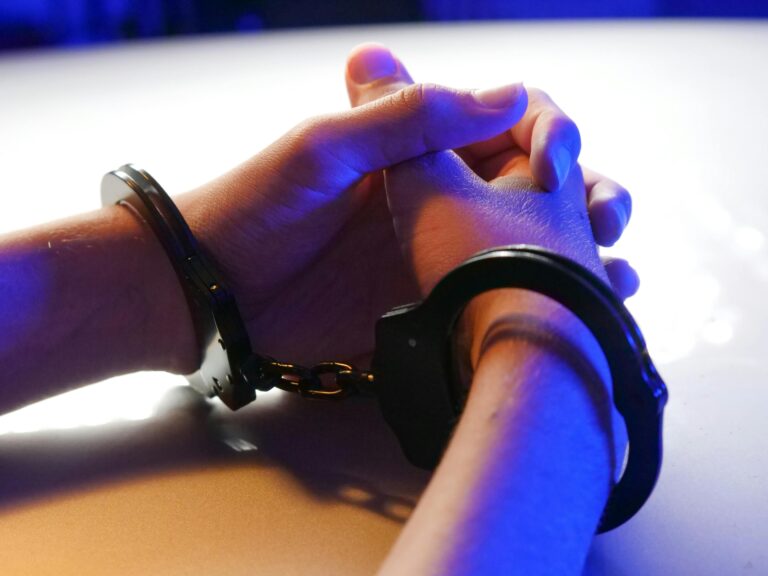person handcuffed criminal charges Queensland